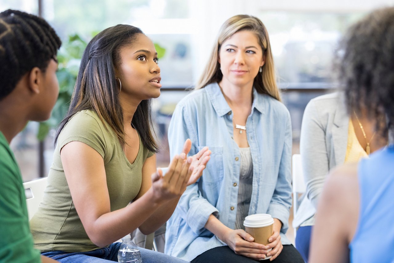 As the teen girl gestures and expresses strong emotion, everybody looks to her.