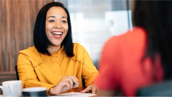 woman smiling in yellow shirt