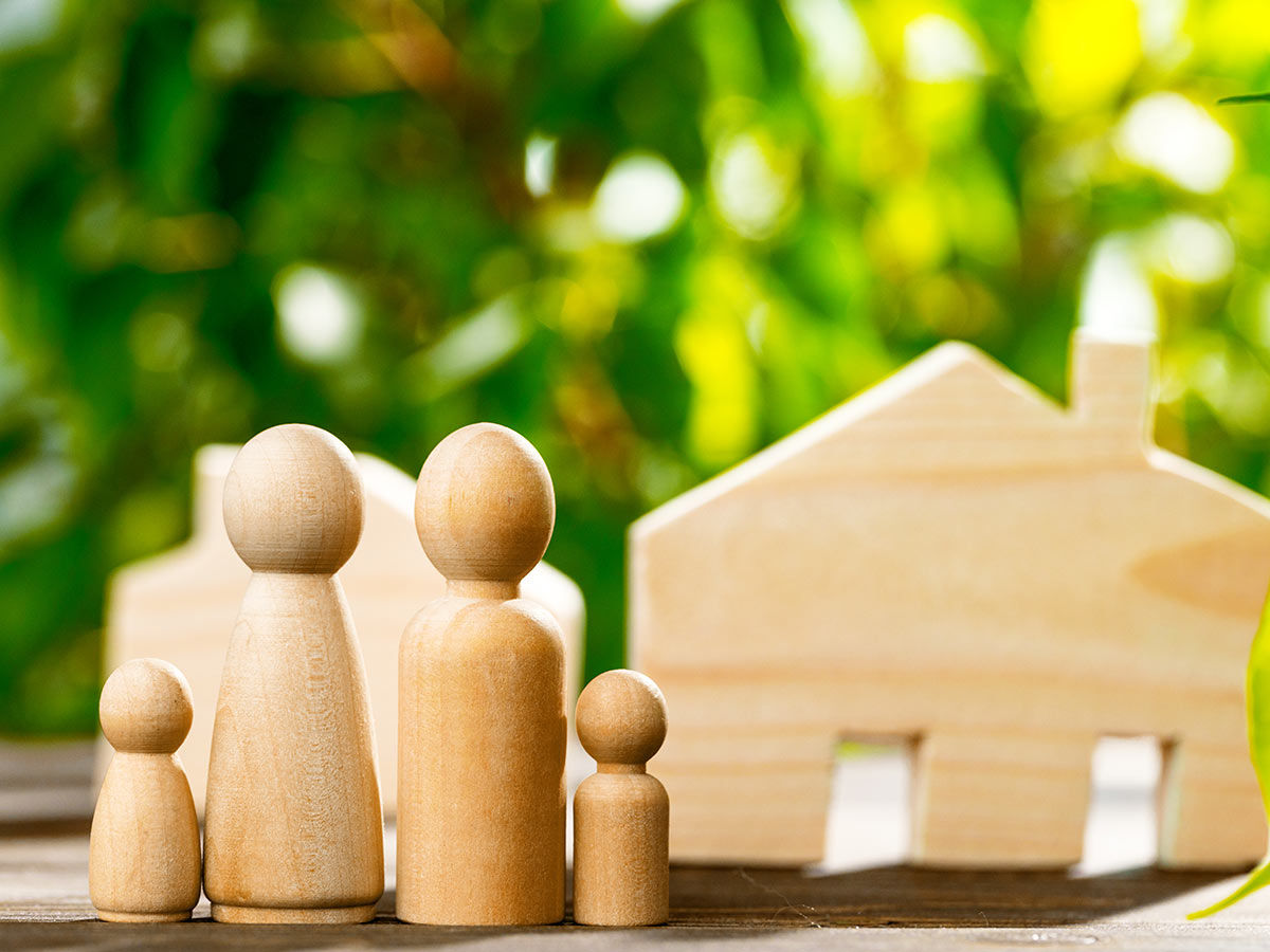 Wooden toy house and wooden family.